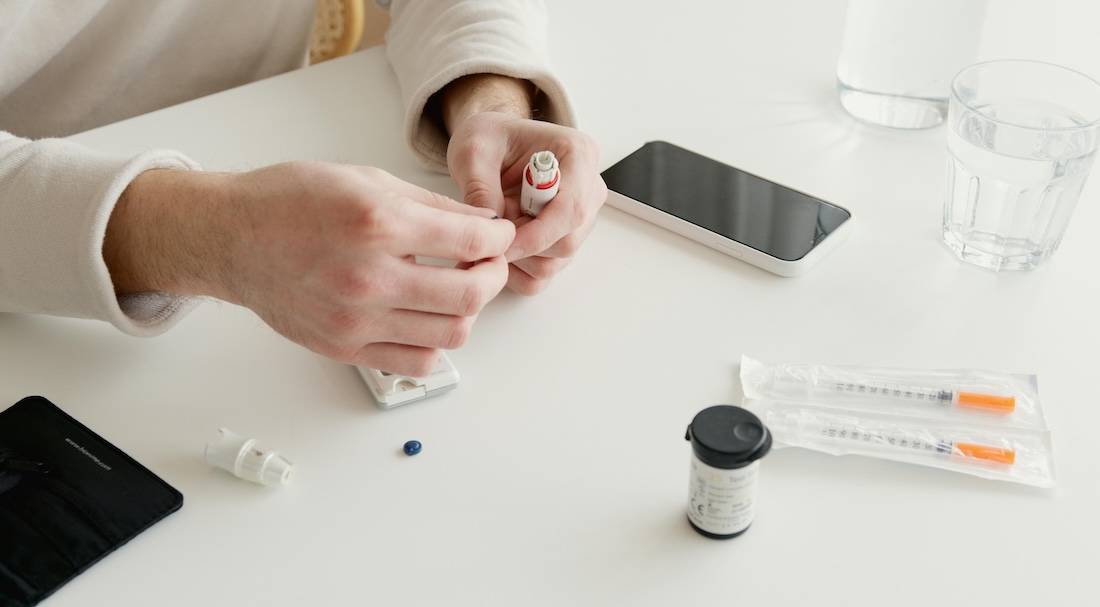 A person prepares an insulin injection with an insulin pen A person prepares an insulin injection with an insulin pen
